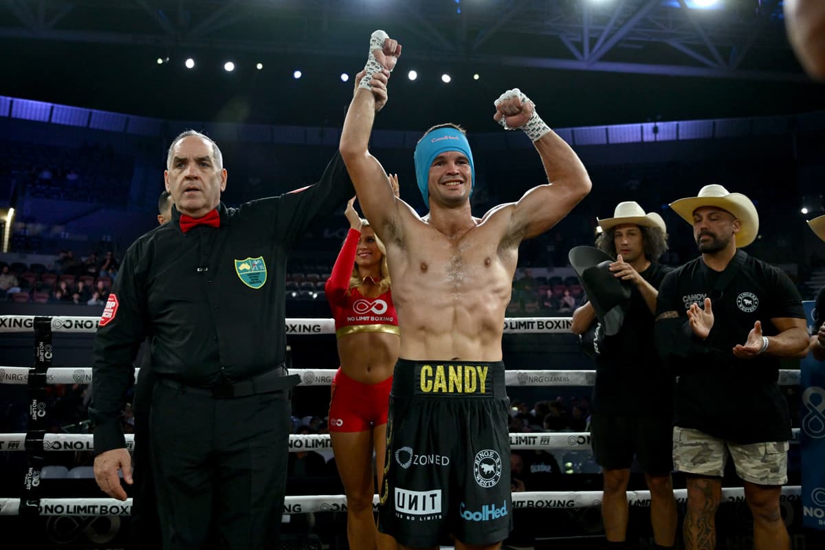 Riley Candy has his hand raised by referee after victory over Brayden Rawlins