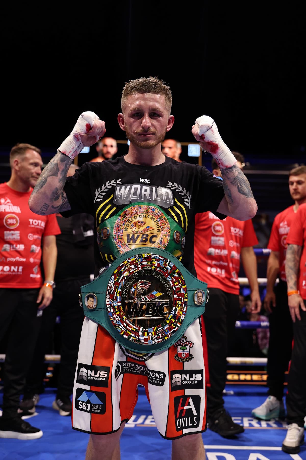 Ryan Garner posing with his belt after victory over Michael Magnesi