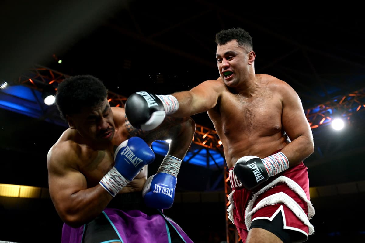 Stevan Ivic throws a punch during his bout against Caleb Tialu