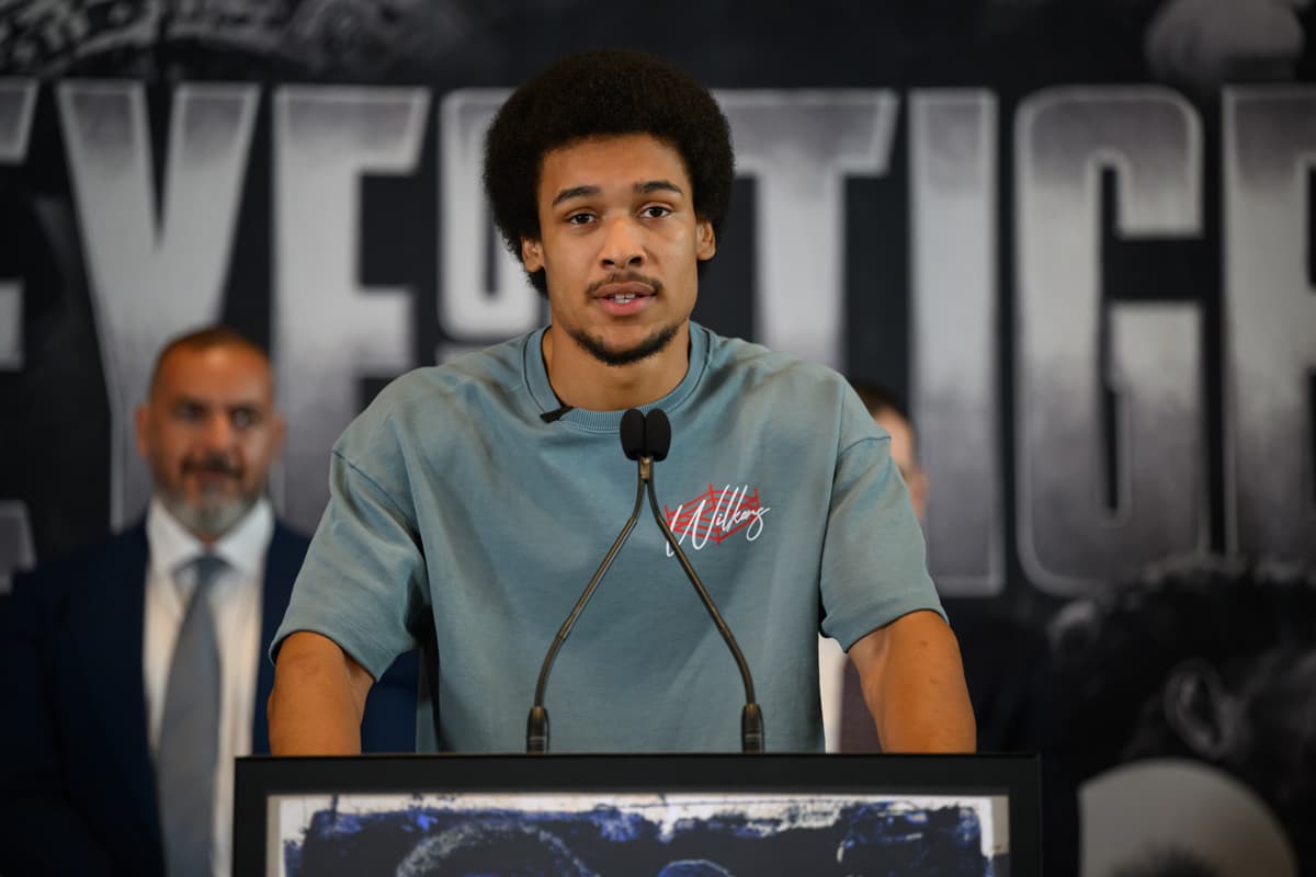 Wilkens Mathieu speaking into a microphone during a press conference