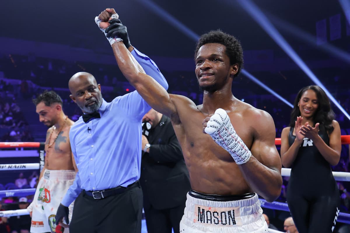 The referee raises Abdurrahman Mason's hand in victory over Alvaro Huizar Cabral during their bout