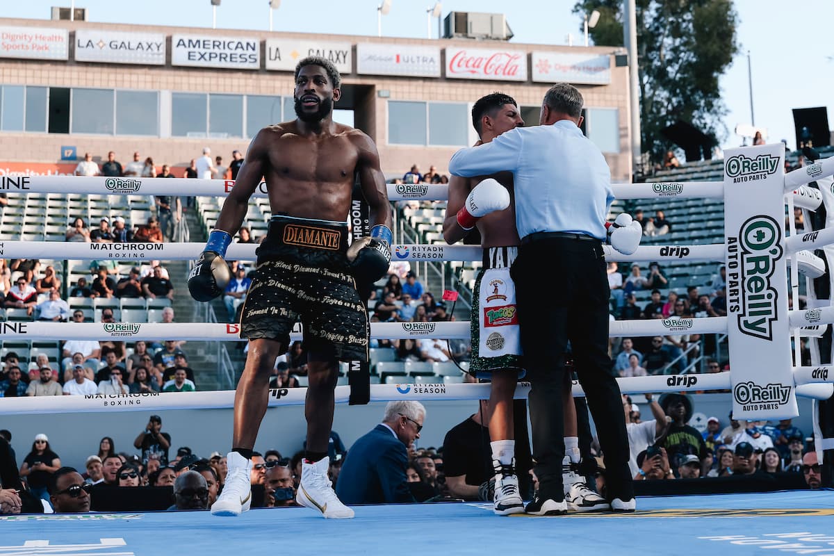 Andy Cruz walks off as the referee attends to Abraham Montoya during their bout