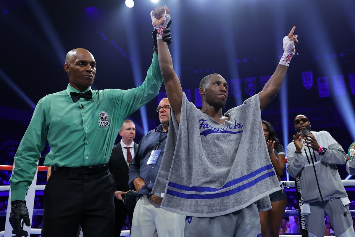 The referee raises Bruce Carrington's hand in victory over Rene Palacios