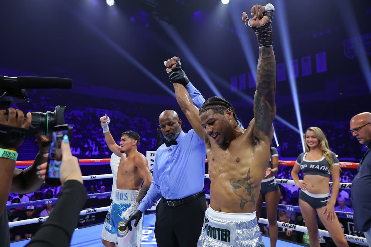 The referee raises Deric Davis' hand in victory over Carlos Ramos during their bout