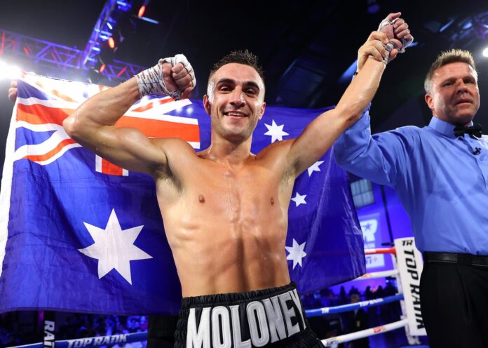 Jason Moloney has his hand raised by the referee after defeating Francisco Javier Pedroza