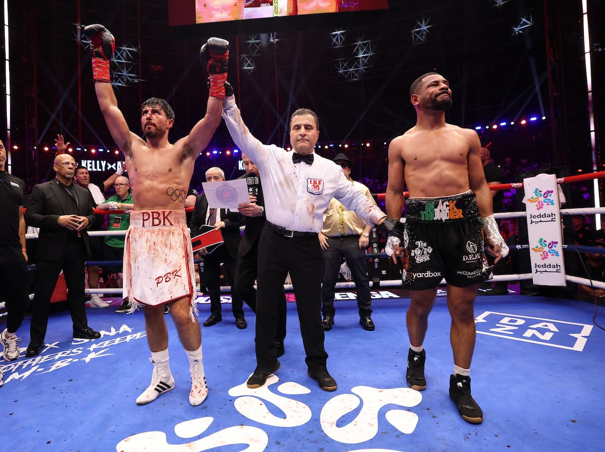 Josh Kelly has his hand raised by the referee after his victory over Caoimhin Agyarko