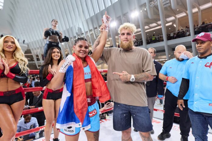 Jake Paul raises Krystal Rosado's hand in victory