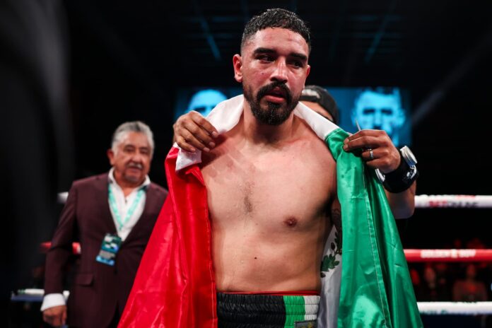 Raul Curiel draped in the Mexican flag as his bout against Jordan Panthen concludes