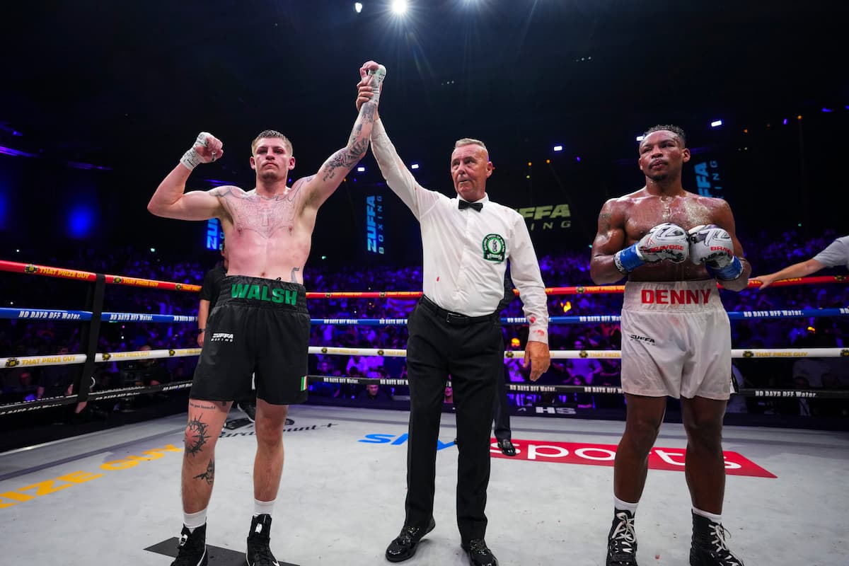 Callum Walsh has his hand raised by the referee after his victory over Tyler Denny