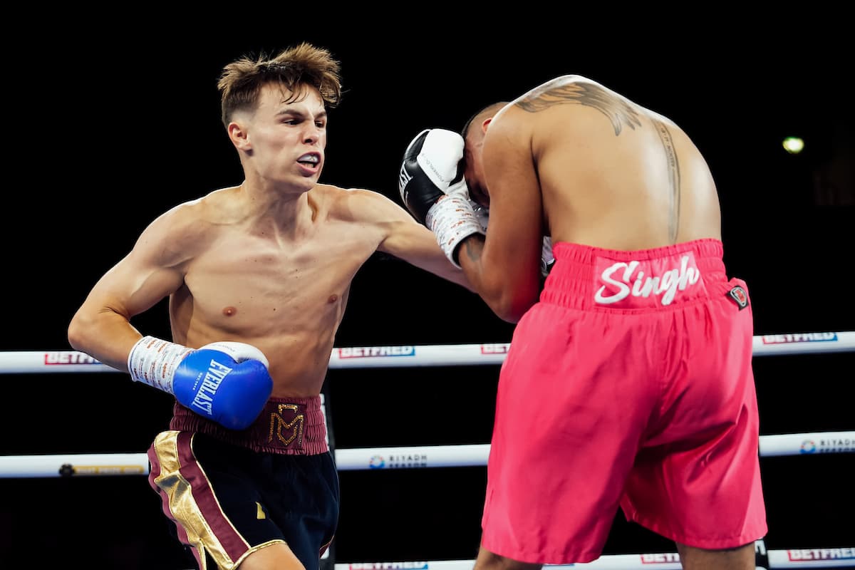 Connor Mitchell lands a punch during his bout against Caine Singh