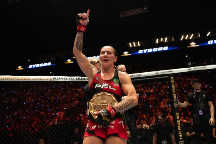 Cris Cyborg with her championship belt after her victory over Sara Collins