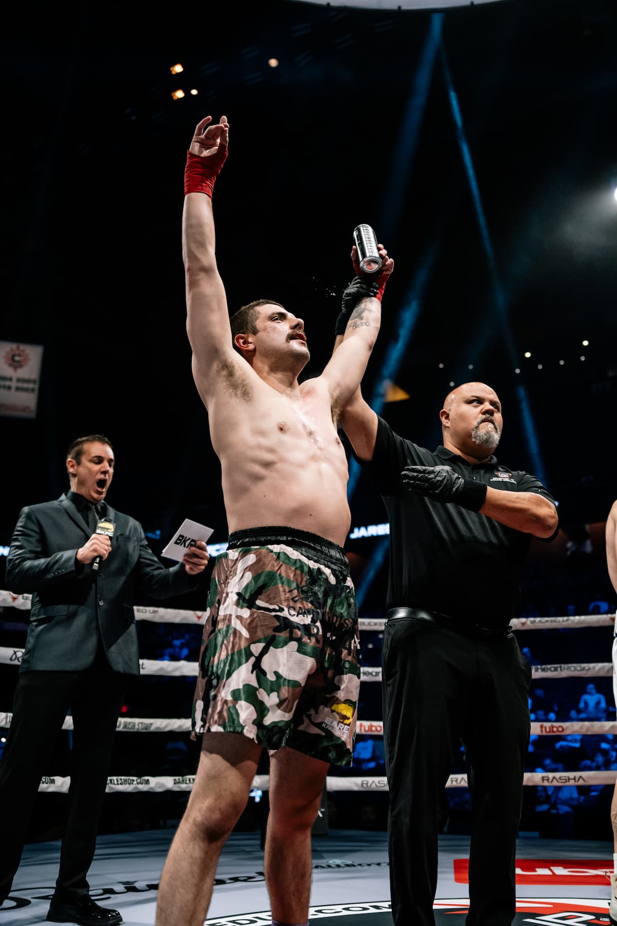 Dominick Carey has his hand raised by the referee after his victory over Jared Lennon