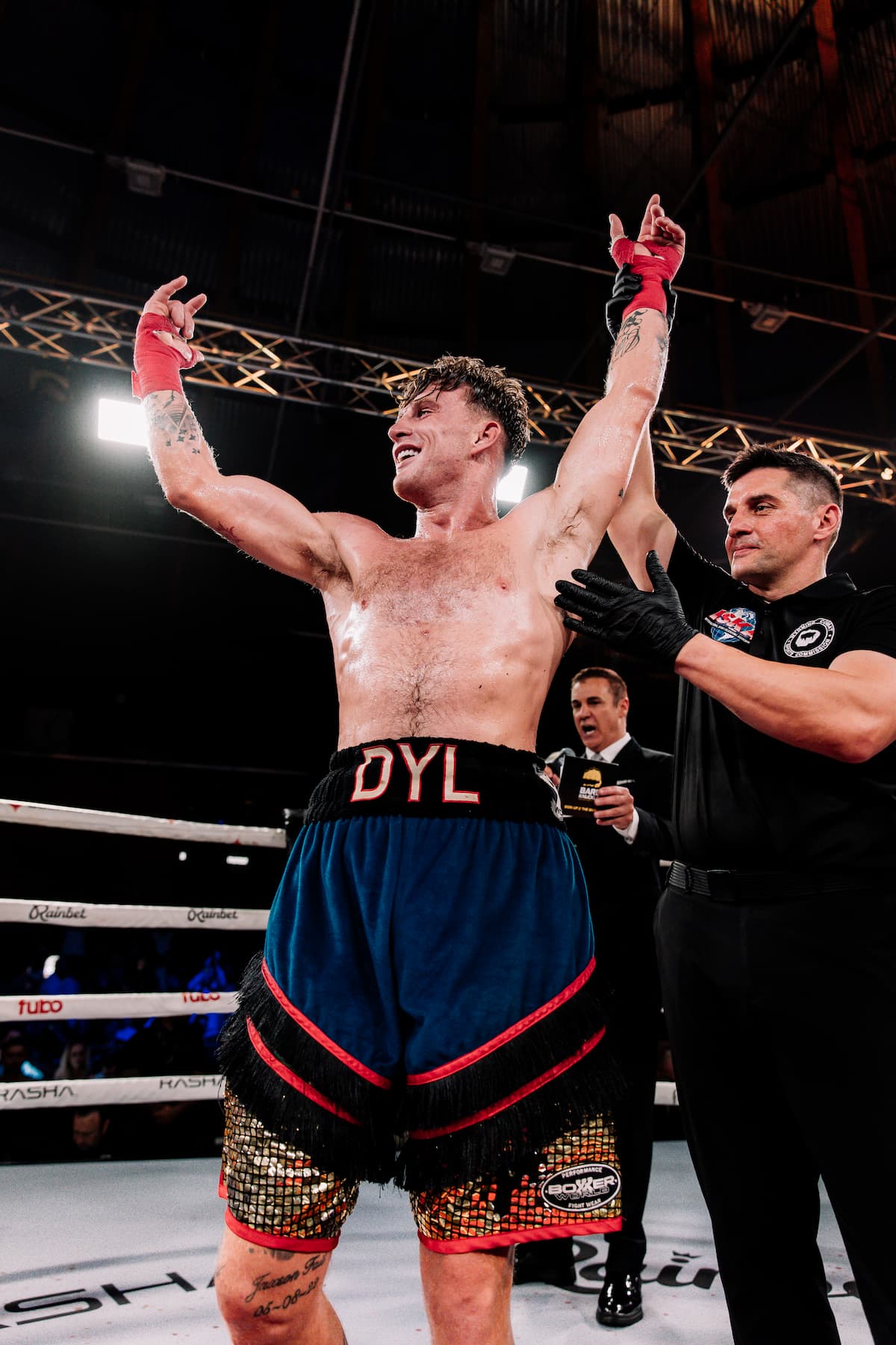 Dylan Fail has his hand raised by the referee after his victory over Liam Hutchinson