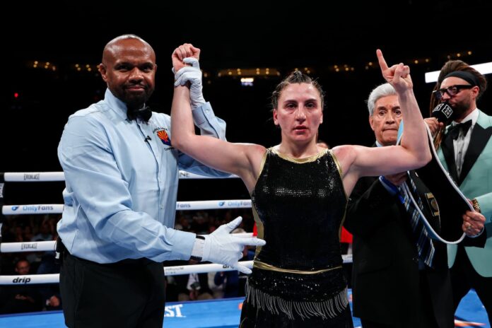 Elif Nur Turhan has her hand raised by the referee after her victory over Gabriela Tellez