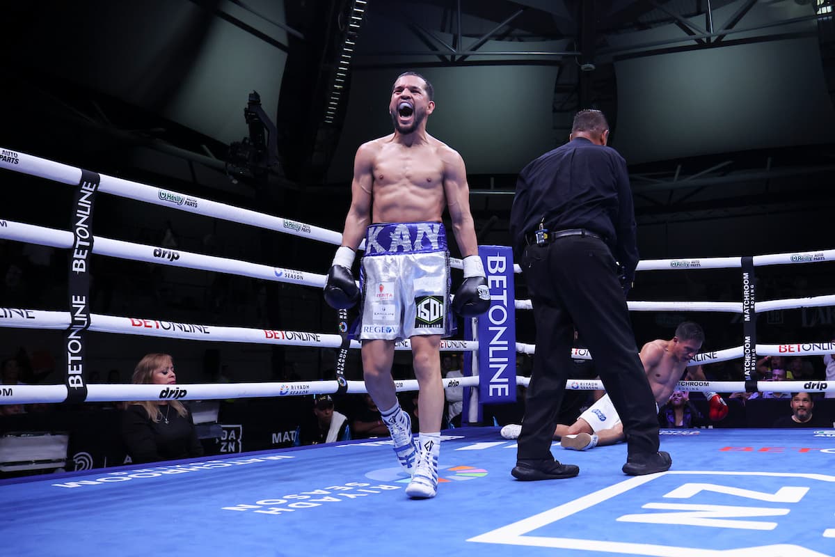 Jorge Mata walks away celebrating his victory as Luis Ronaldo Ruelas Martinez is down on the canvas