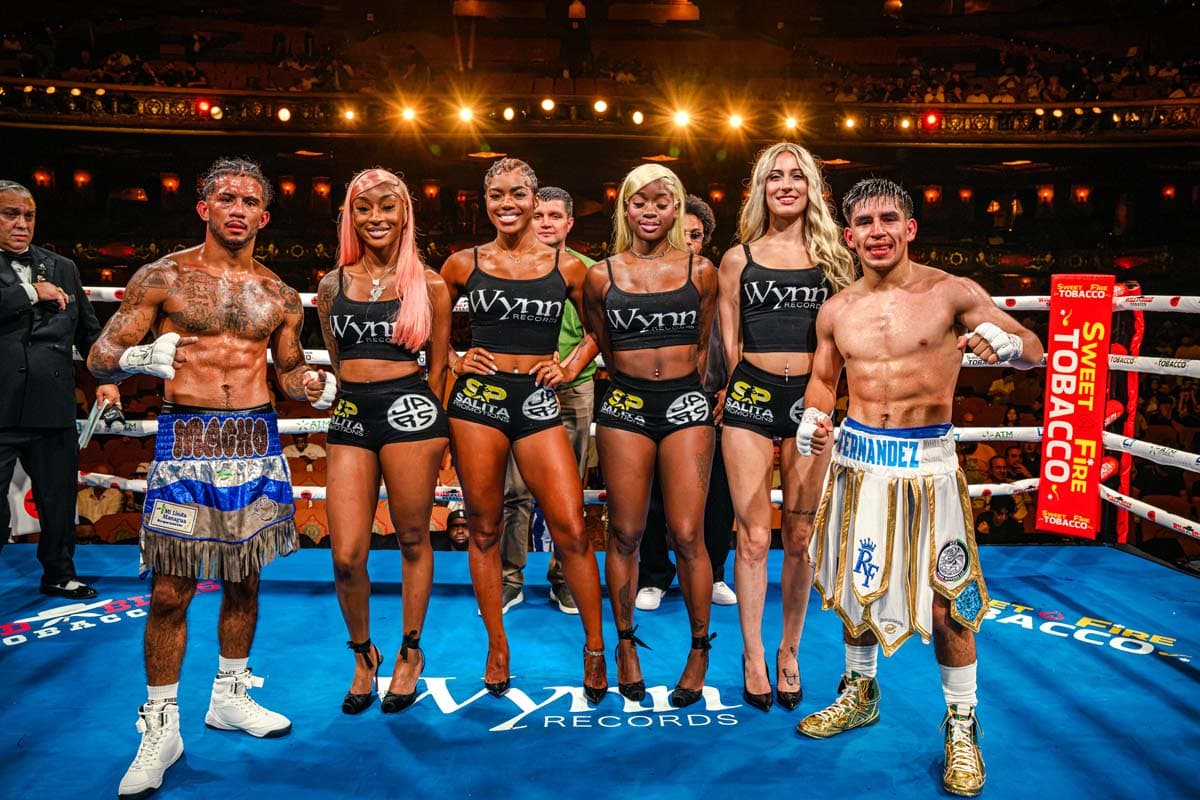 Joshua Moreno and Richard Fernandez Jr. pose with ring girls after their bout ended in a draw