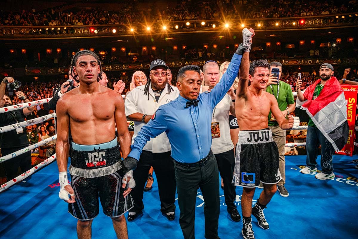 Julius Ballo has his hand raised in victory over Julian Gomez-Clemons