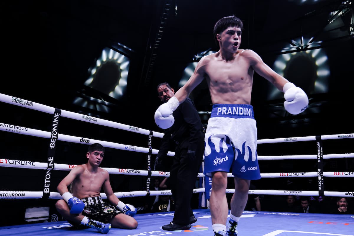 Roberto Carbajal walks away as Lenin Ulises Barron Acosta sits on the canvas