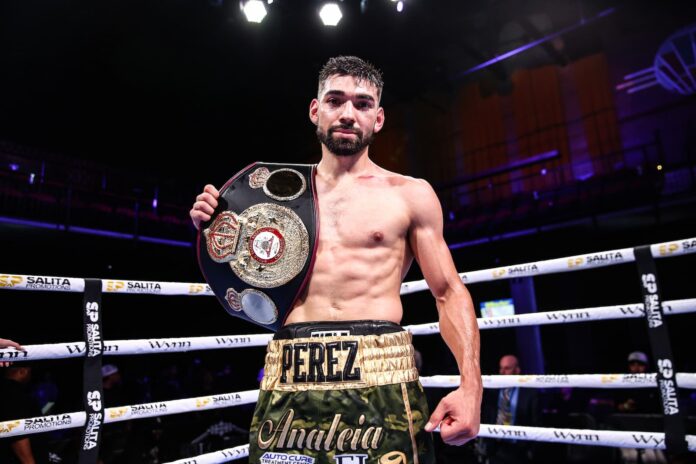 Abraham Perez poses with his championship belt after his victory over Jonathan Gonzalez