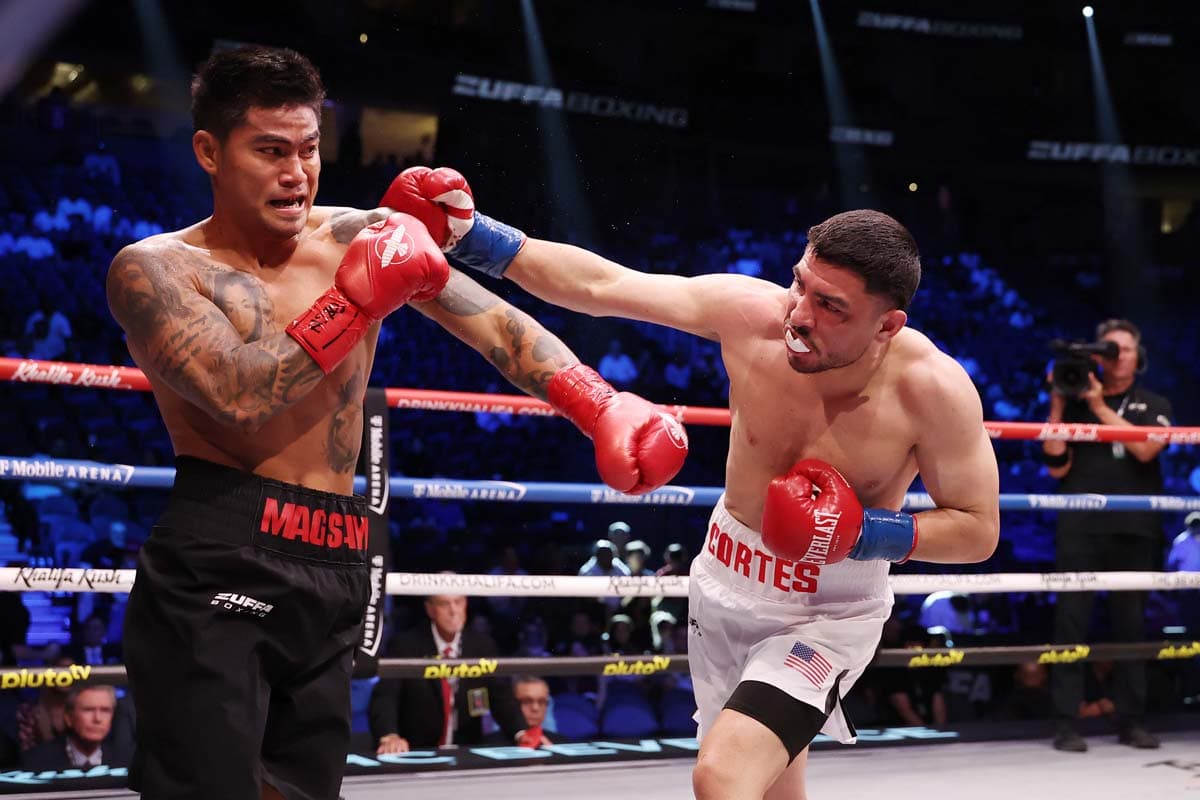 Andres Cortes lands a punch during his bout against Mark Magsayo