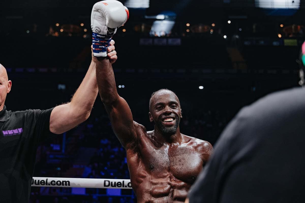 Ashley "Rak-Su" Fongho has his hand raised in victory after defeating Warren Spencer