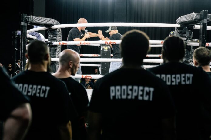 Prospects watch fighters in the ring during BKFC tryouts at the 2300 Arena in Philadelphia