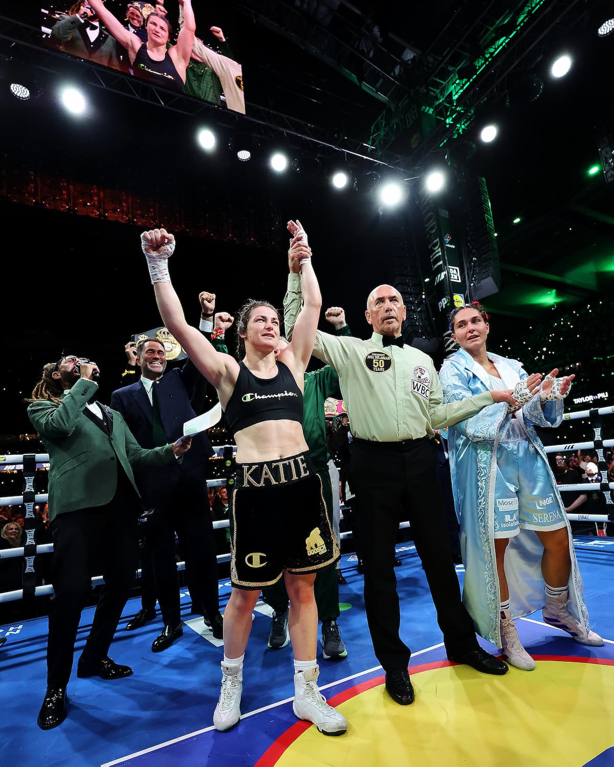 Katie Taylor has her hand raised by the referee after her victory over Flora Pili