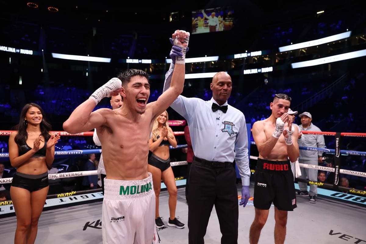 Oswaldo Molina has his hand raised in victory after his bout against Pablo Rubio