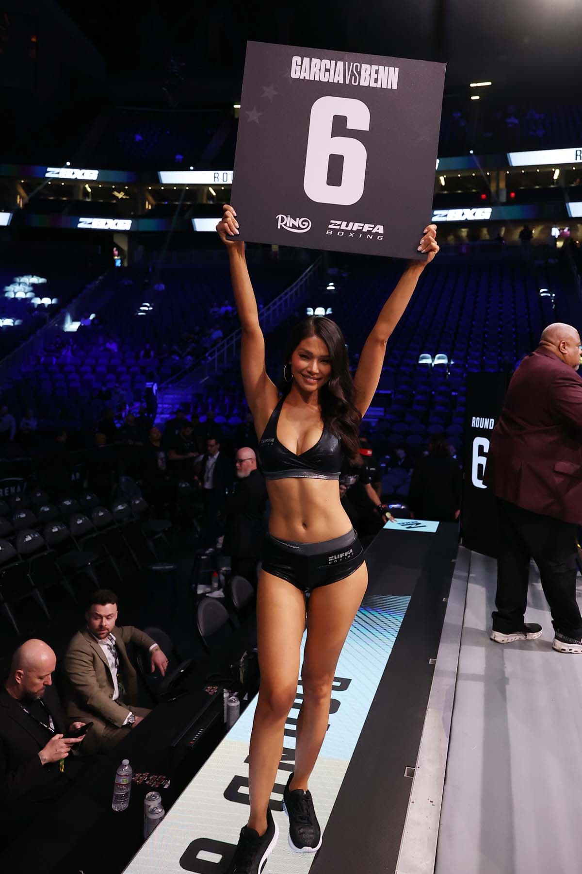 Red Dela Cruz presents the card between rounds during the fight