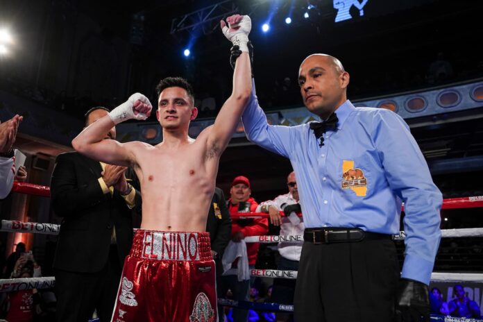 Ricardo Sandoval has his hand raised by referee Raul Caiz Jr. in victory over Jerson Ortiz