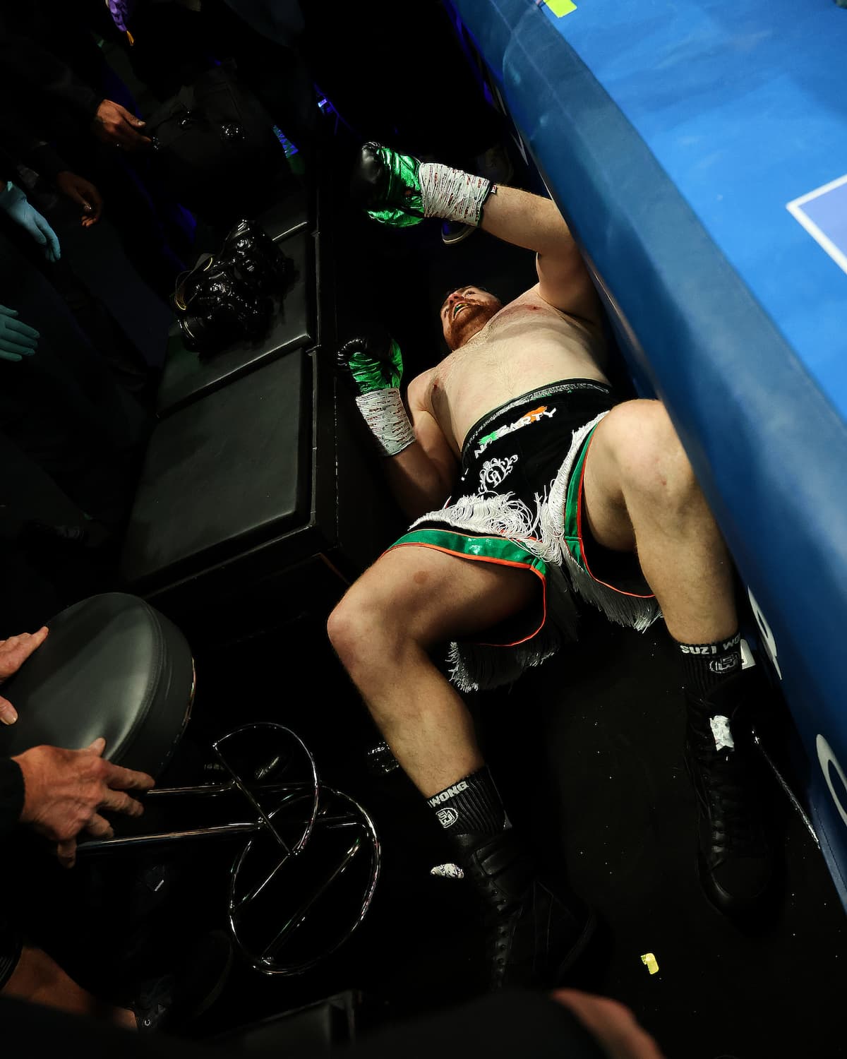Thomas Carty lies ringside after falling out of the ring during his bout against Dave Allen