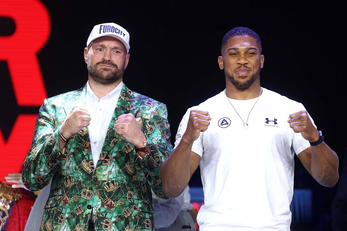 Tyson Fury and Anthony Joshua pose together during the press conference in London