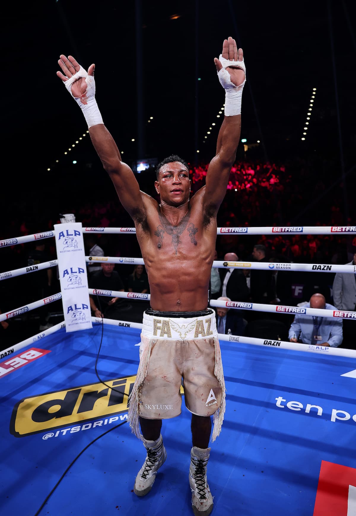 Bilal Fawaz raises his hands in victory over Eithan James