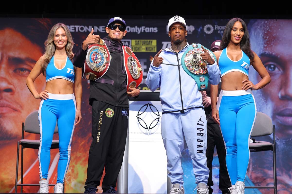Emanuel Navarrete and O'Shaquie Foster pose with ring girls during a press conference