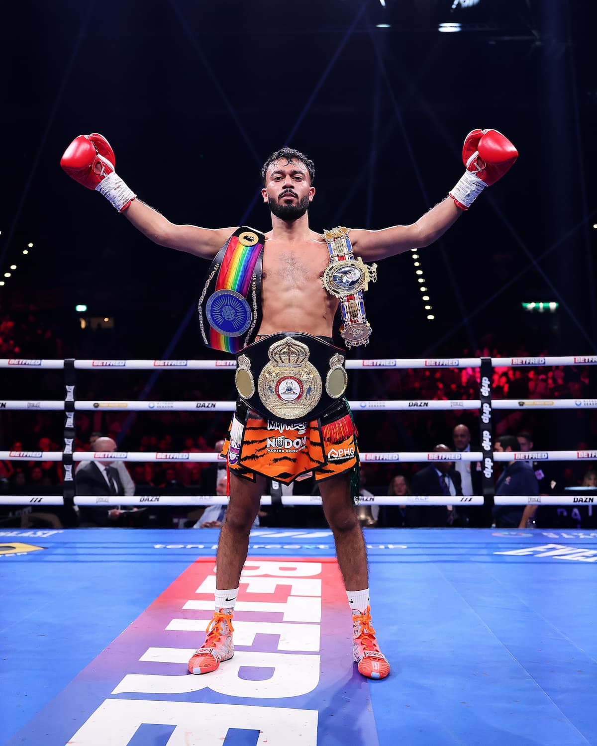 Hamza Uddin poses with his championship belts
