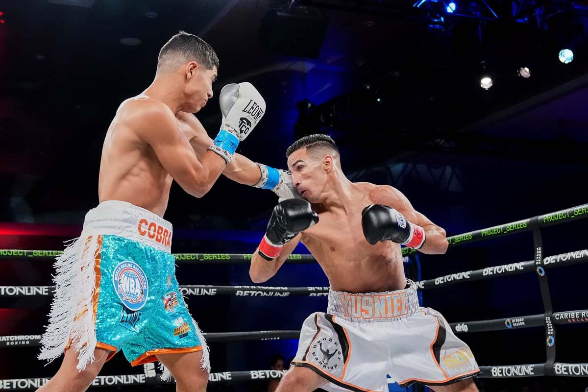 Jordan Orozco Hernandez lands a jab on Yusniel Abrahante during their bout