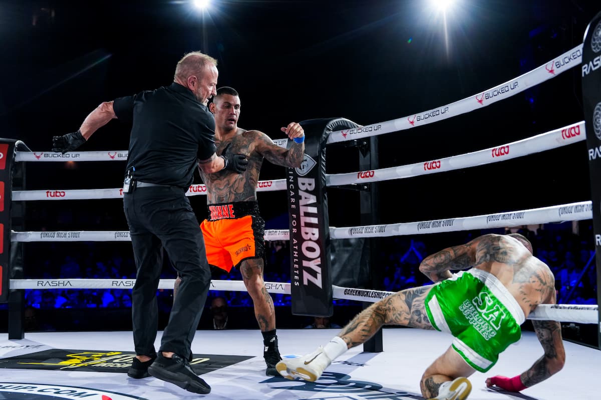 Josh Kuhne knocks down Shaun Curran during their bout