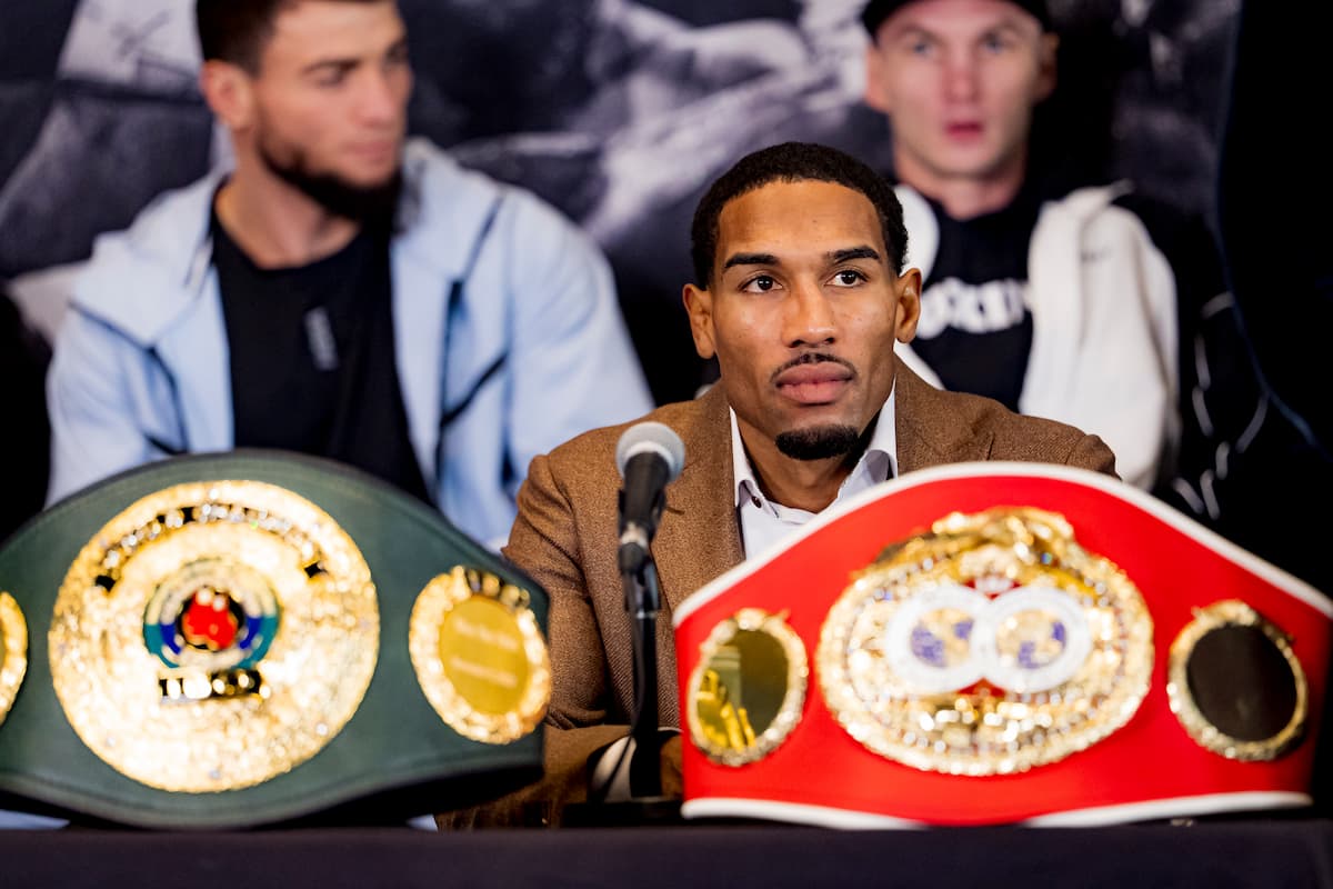 Osleys Iglesias sits with his IBF and IBO championship belts during the press conference