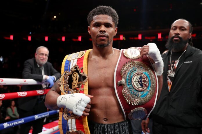 Shakur Stevenson poses with his Ring and WBO championship belts after defeating Teofimo Lopez